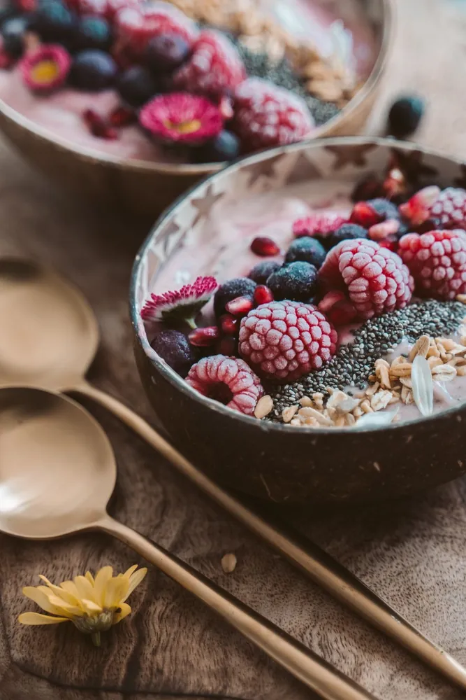 Breakfast bowls topped with fruits and grains
